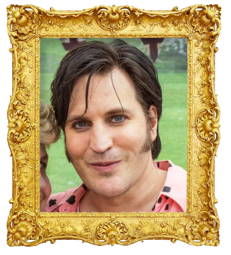 Headshot photo of Noel Fielding surrounded with an ornate golden frame.