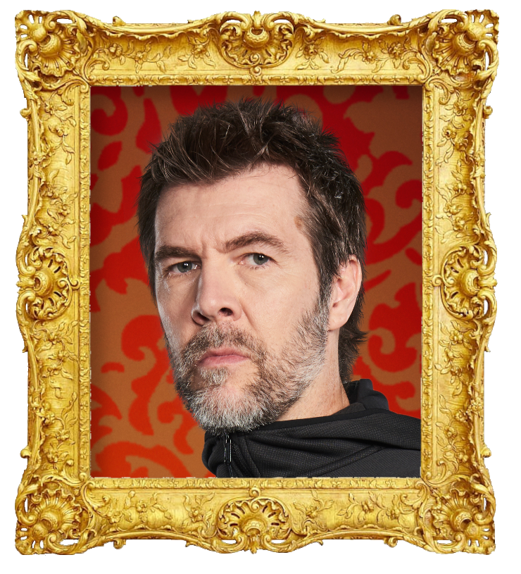 Headshot photo of Rhod Gilbert surrounded with an ornate golden frame.