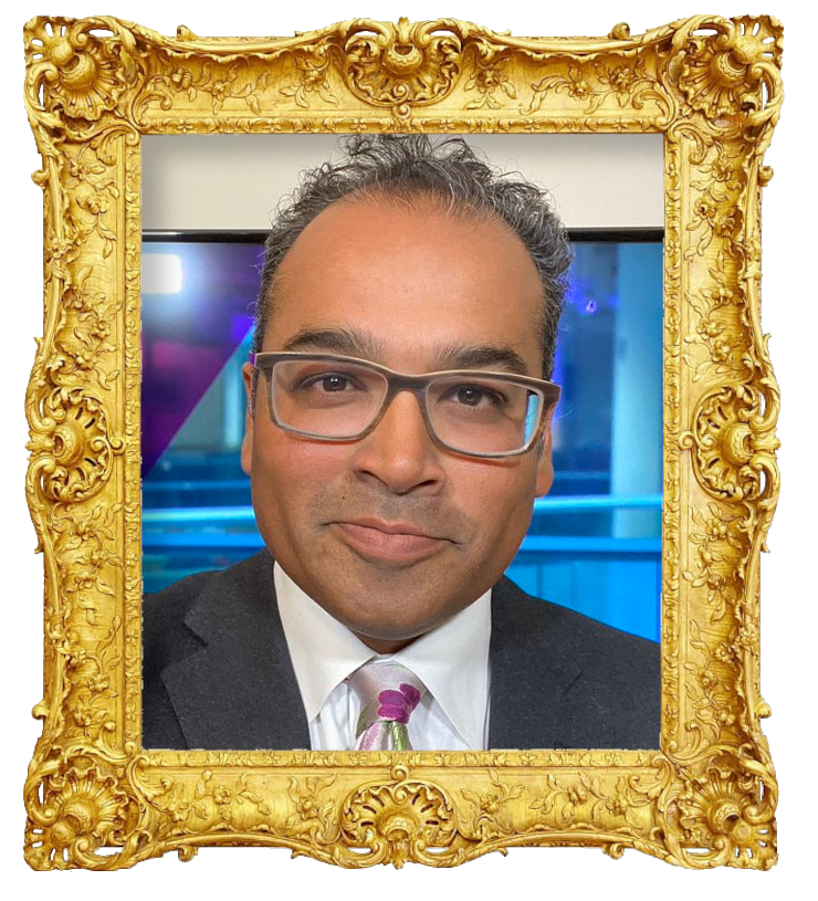 Headshot photo of Krishnan Guru-Murthy surrounded with an ornate golden frame.