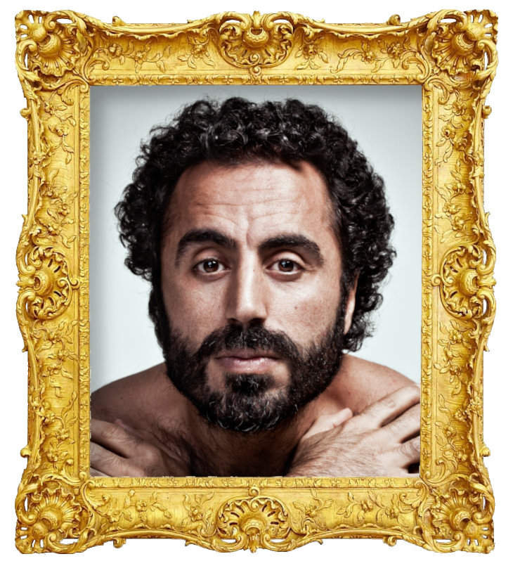 Headshot photo of Özz Nûjen surrounded with an ornate golden frame.