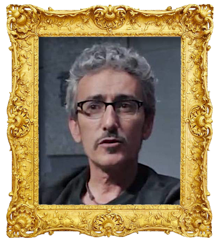 Headshot photo of David Fernández surrounded with an ornate golden frame.