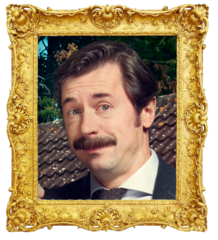 Headshot photo of Mike Wozniak surrounded with an ornate golden frame.