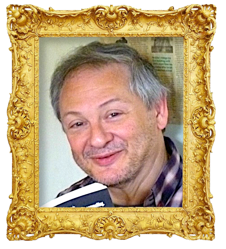 Headshot photo of Bruce Dessau surrounded with an ornate golden frame.
