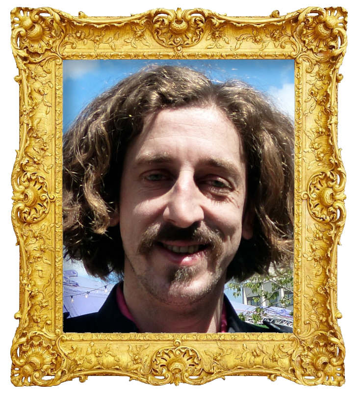 Headshot photo of Tom Wrigglesworth surrounded with an ornate golden frame.