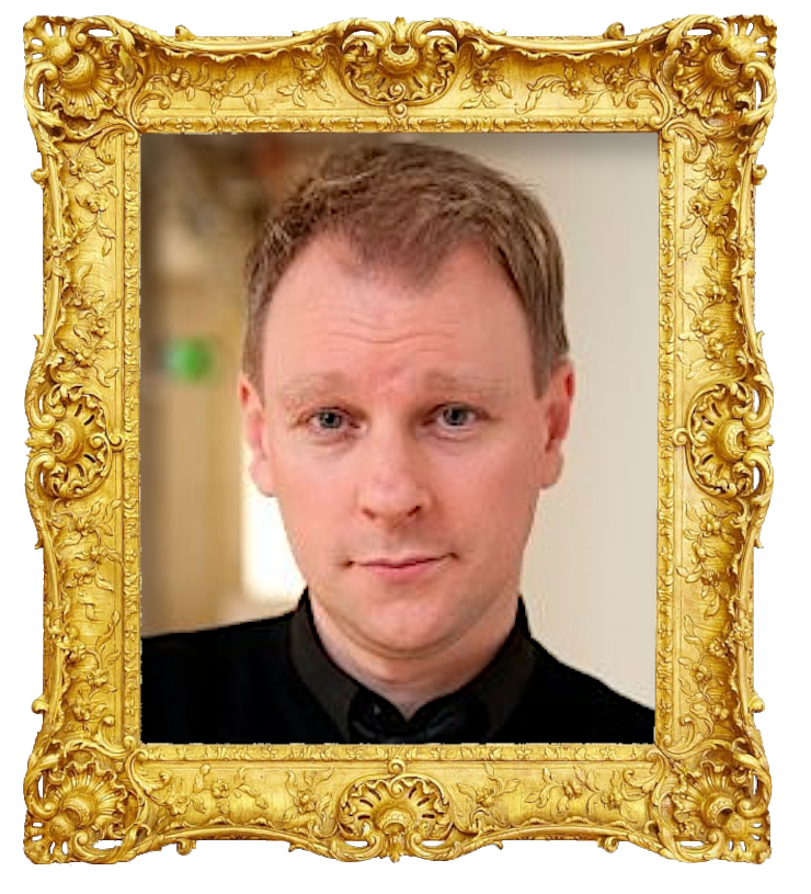 Headshot photo of Alan Tyler surrounded with an ornate golden frame.