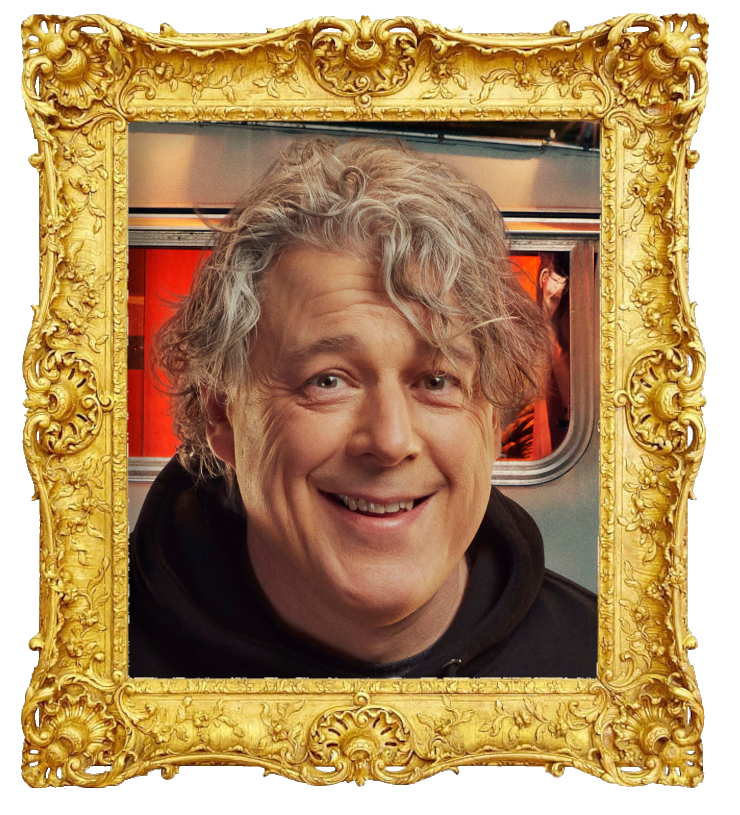 Headshot photo of Alan Davies surrounded with an ornate golden frame.