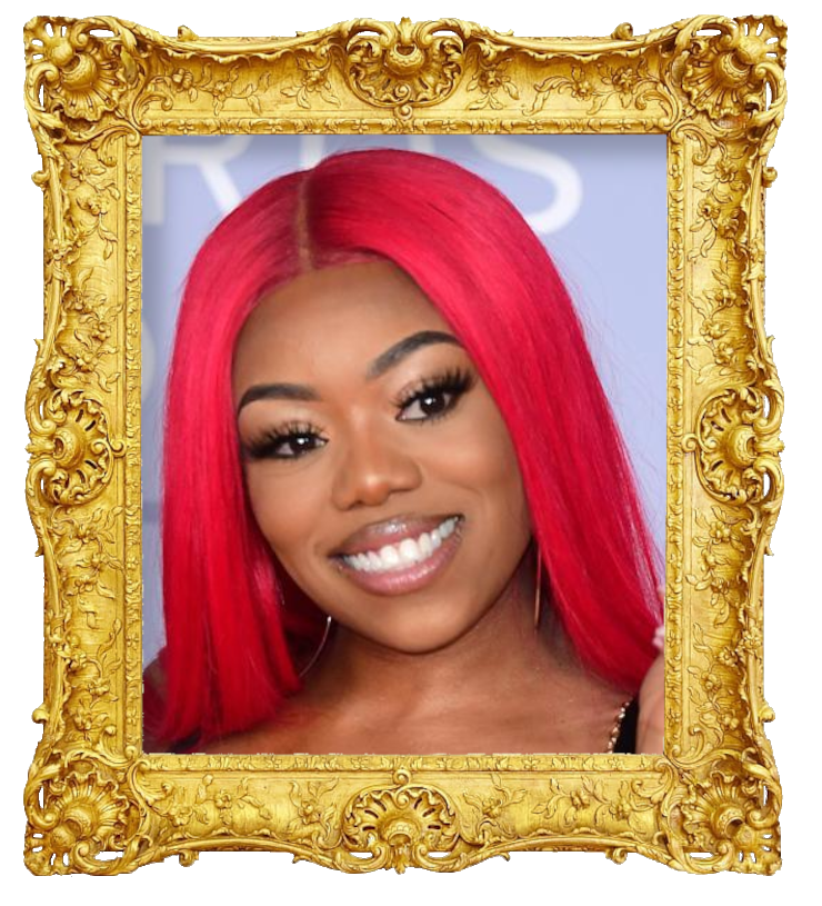 Headshot photo of Lady Leshurr surrounded with an ornate golden frame.