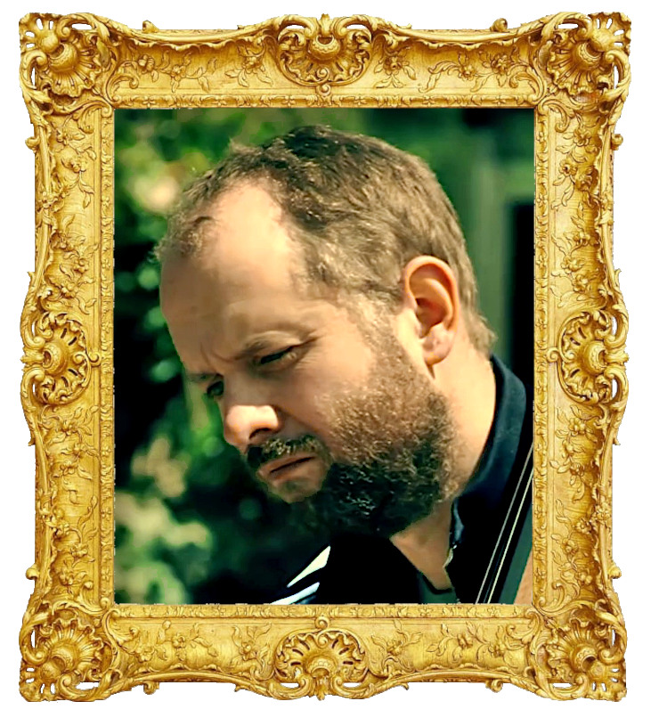 Headshot photo of Will Collier surrounded with an ornate golden frame.