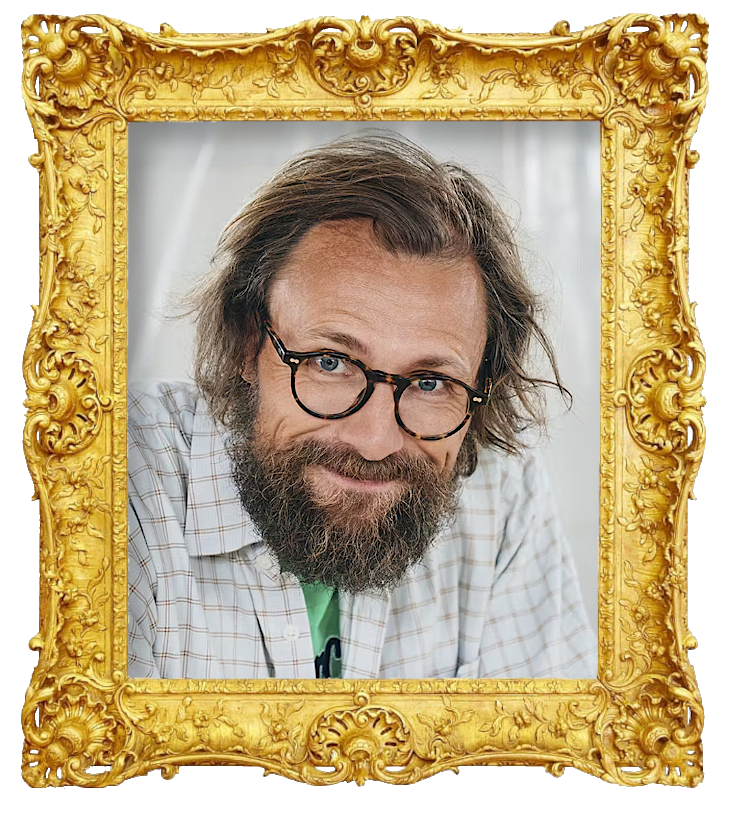 Headshot photo of Carsten Eskelund surrounded with an ornate golden frame.