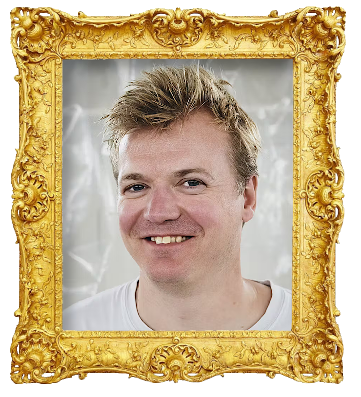 Headshot photo of Tobias Dybvad surrounded with an ornate golden frame.