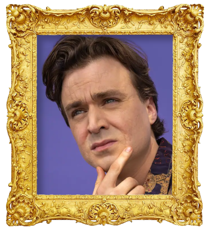 Headshot photo of Arnaud Soly surrounded with an ornate golden frame.