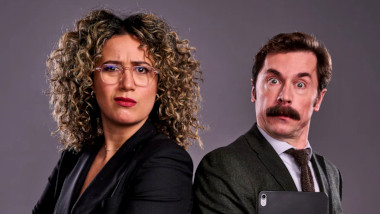 Cover image for the UK show Junior Taskmaster, showing the hosts of the show, Rose Matafeo and Mike Wozniak.