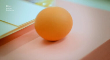 Image of an egg on top of a ream of coloured paper, next to the task brief.