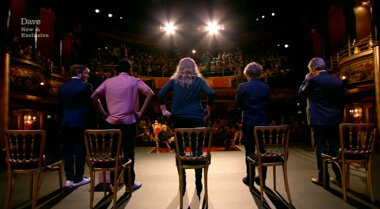 Image taken from behind the contestants after they have all stood up on stage.