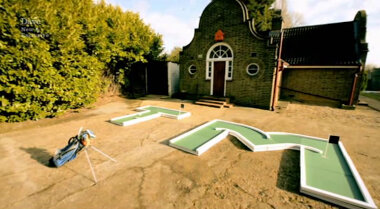 Image showing the first two holes of the mini golf course, which are shaped like the letters ‘T’ and ‘M’.