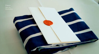 Image showing the task brief on top of a folded, blue and white-striped cooking apron.