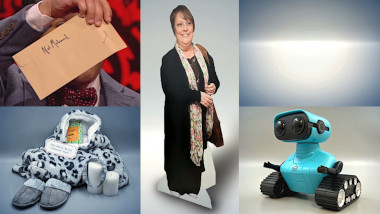 Nick Mohammed holding a signed and sealed envelope (top left), a basic bitch starter kit consisting of slippers, a robe, scented candles, and a cucumber mask (bottom left), a cardboard cut-out of Kathy Burke (centre), nothing (top right), a small toy robot (bottom right).