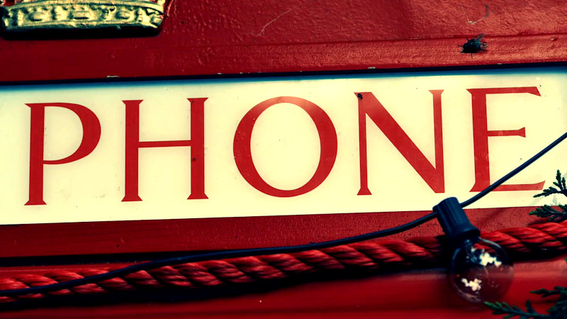 A close-up of a red phone booth.