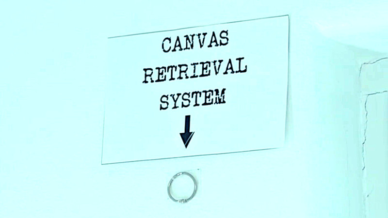 A sign for a 'canvas retrieval system' indicates a metal ring on the wall.