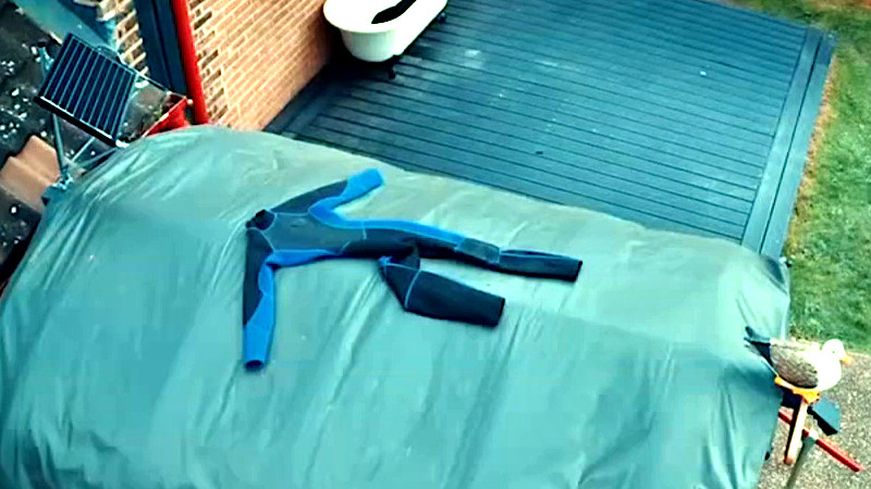 A wetsuit laid on top of the hutch.