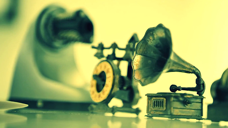 A phonograph on a shelf, alongside other 1800s-style technologies.