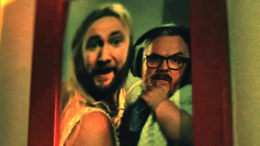 A family photo of a mother holding a baby, but with Alex's face pasted onto the mother, and Greg's face pasted onto the baby.