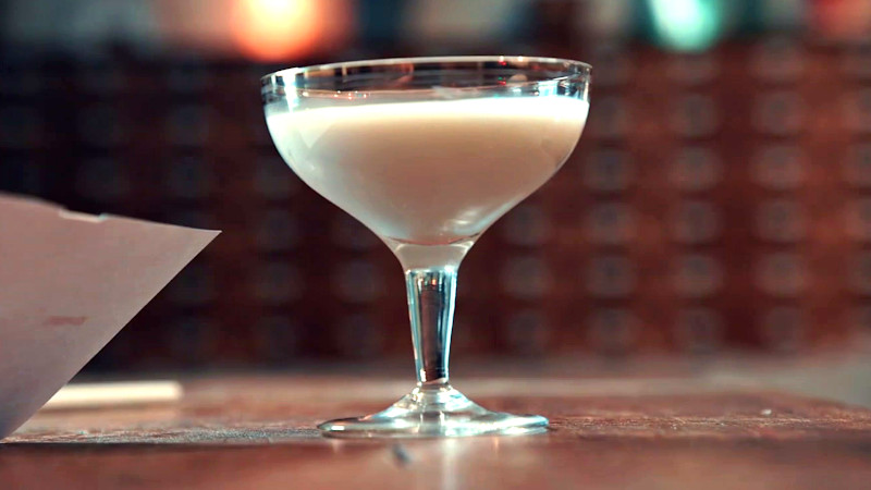 A cocktail glass filled with plain yoghurt.