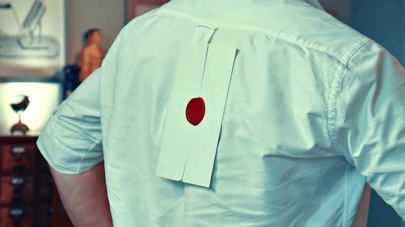 A task envelope stuck to Jason's back.