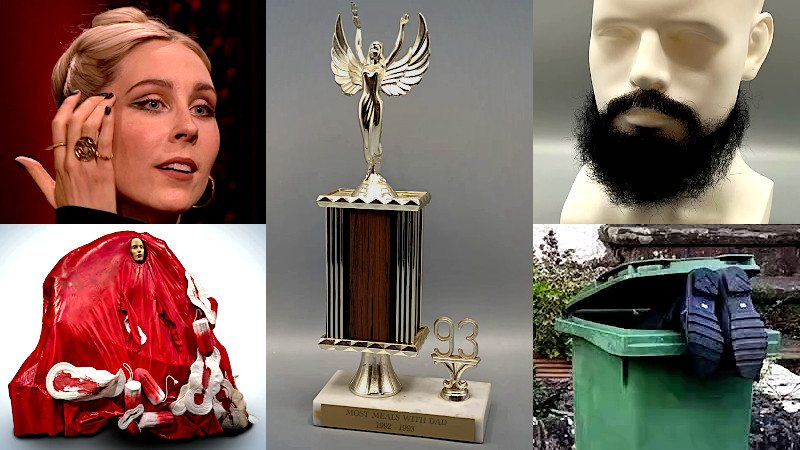 Stevie patting her face, a costume featuring bloody pads and tampons on a mound of red, a false beard, a trophy labelled 'Most meals with Dad', and some boots sticking out of a wheelie bin.