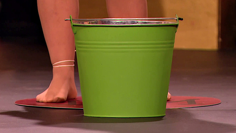 Rosie's feet behind her bucket on the stage.